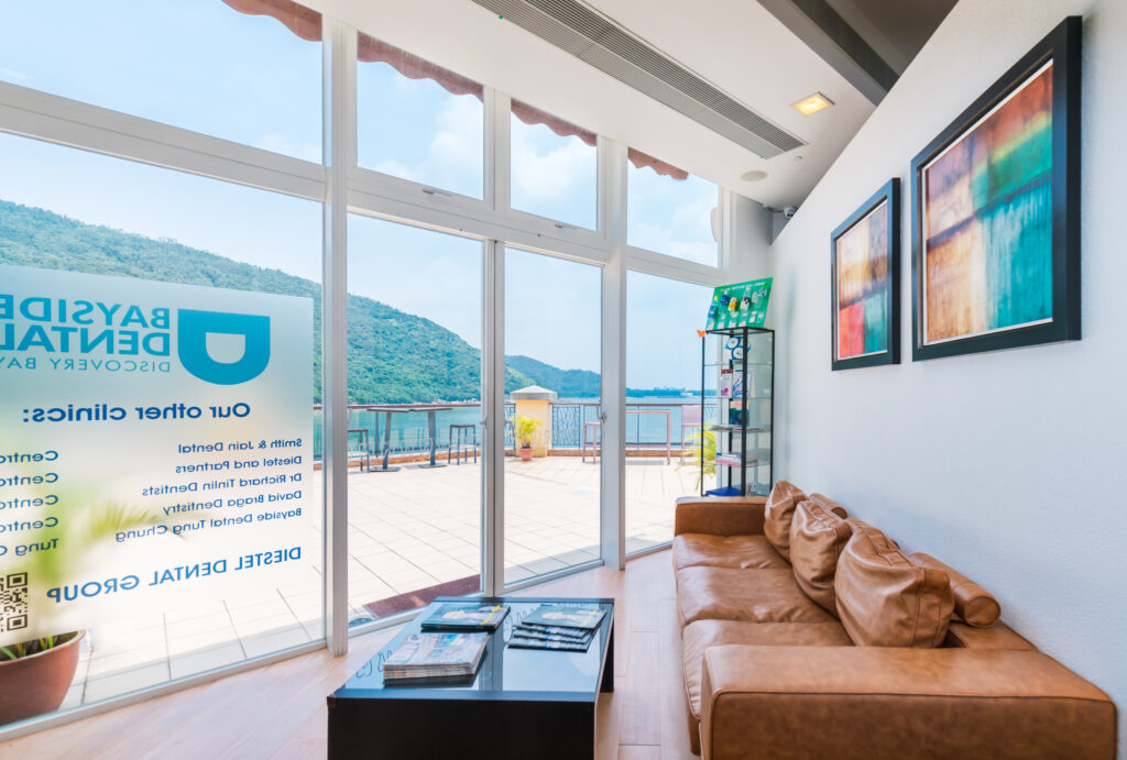 This is the environment image of Bayside Dental Discovery Bay, showcasing a comfortable waiting area with sea views, offering dental services including the prevention and treatment of cavities in baby teeth.